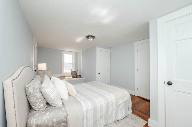 bedroom with wood finished floors and baseboards