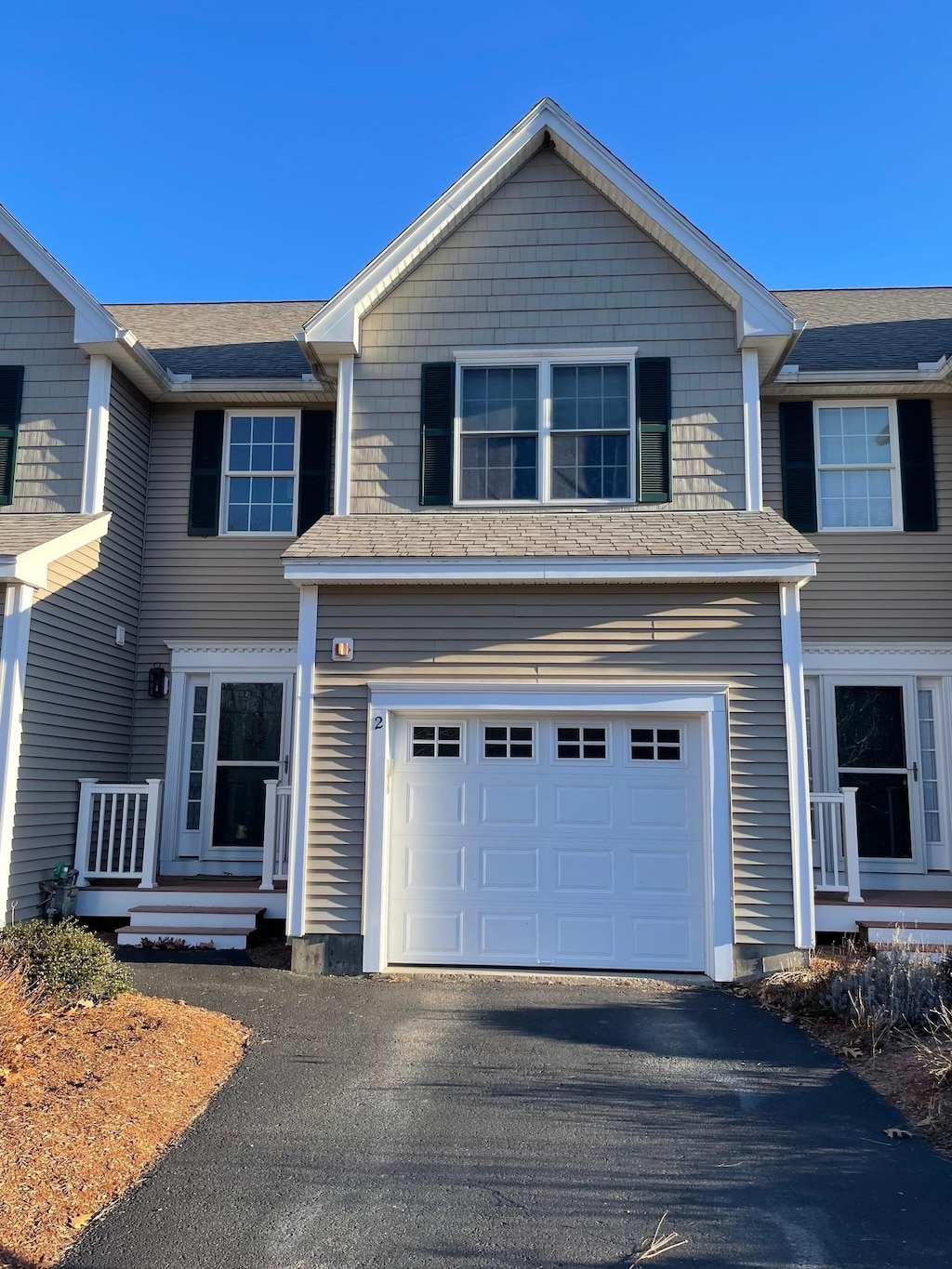 view of front of property with aphalt driveway and an attached garage