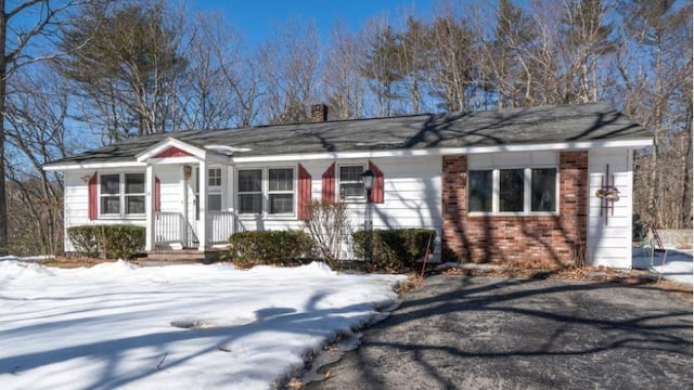 single story home with brick siding and a chimney