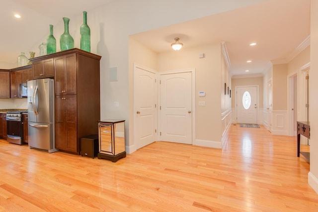 kitchen featuring recessed lighting, light wood-style flooring, appliances with stainless steel finishes, and ornamental molding