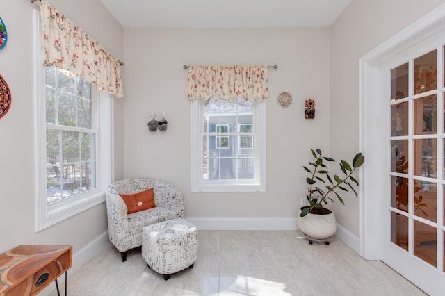 living area with baseboards and plenty of natural light