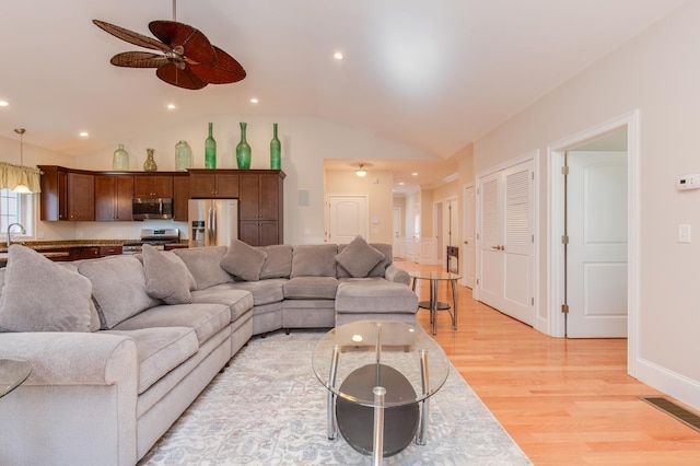 living area featuring recessed lighting, lofted ceiling, light wood-style floors, and ceiling fan