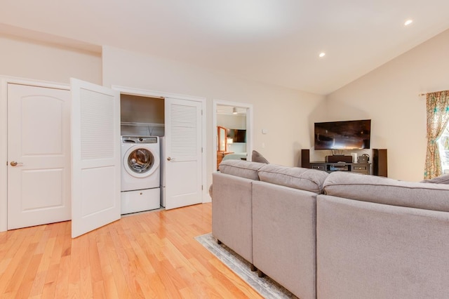 living area featuring recessed lighting, washer / clothes dryer, lofted ceiling, and light wood finished floors