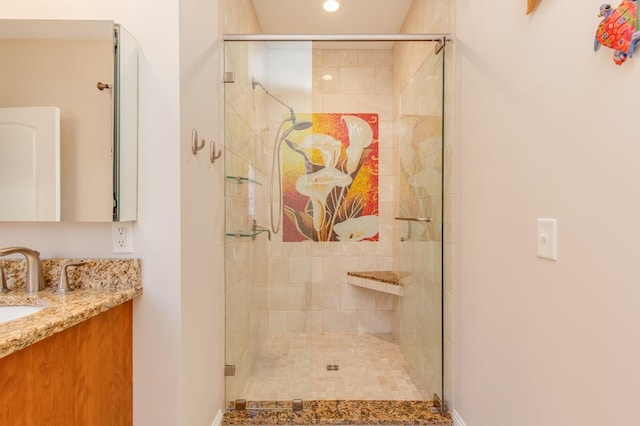 bathroom with a stall shower and vanity