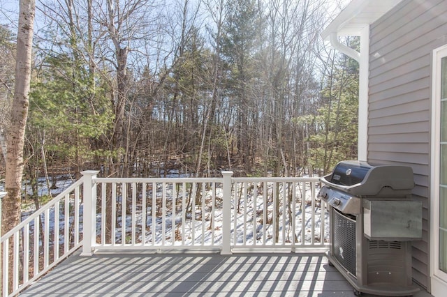 wooden deck featuring a grill