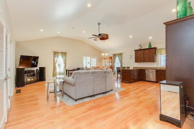 living area featuring recessed lighting, ceiling fan with notable chandelier, light wood-style flooring, and vaulted ceiling