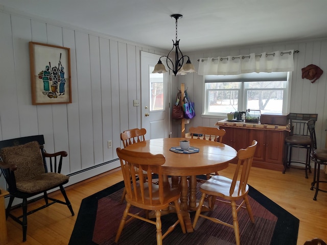 dining area featuring baseboard heating and light wood-type flooring