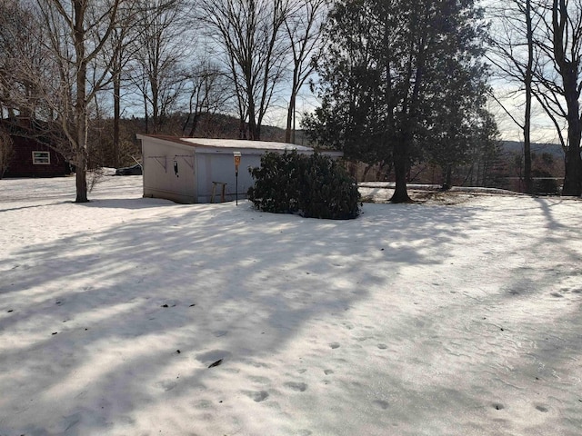 yard layered in snow with an outdoor structure