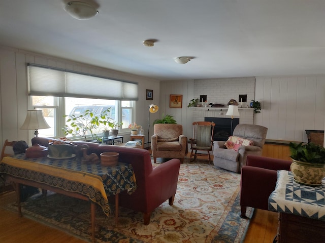 living room with wood finished floors and a fireplace