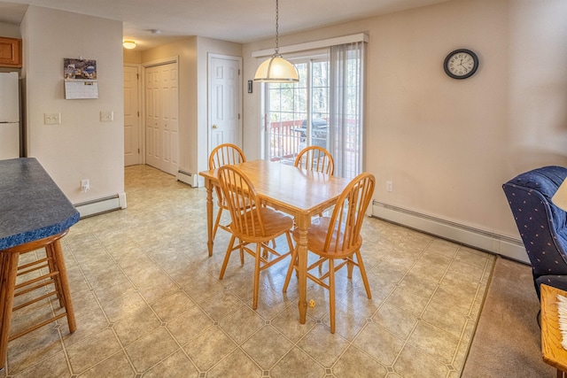 dining space featuring baseboards and a baseboard radiator