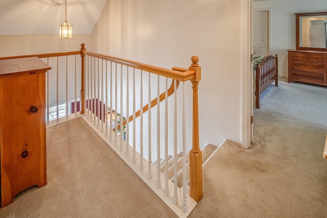 stairway with vaulted ceiling and carpet flooring