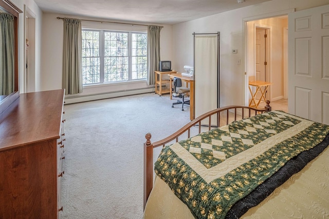 bedroom with a baseboard heating unit and carpet