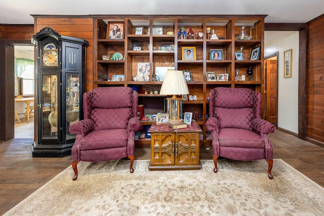 living area with wood finished floors and wood walls