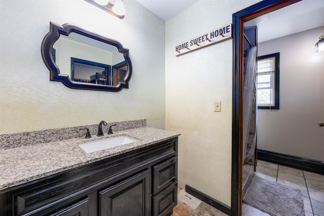 bathroom featuring baseboards and vanity