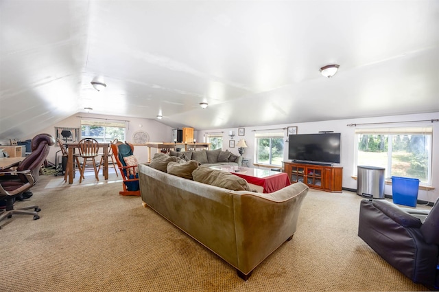 living area with lofted ceiling and light colored carpet