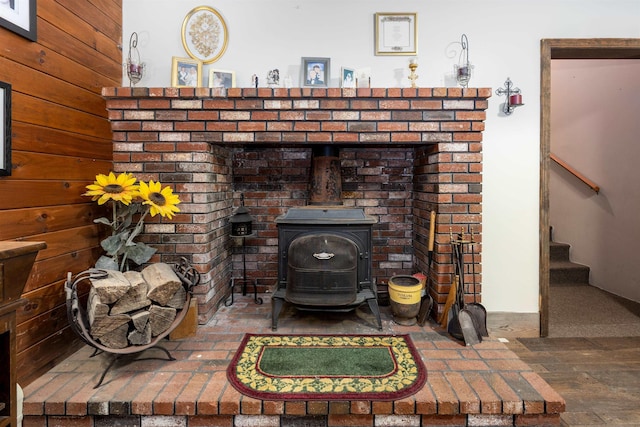 room details featuring wood finished floors and a wood stove