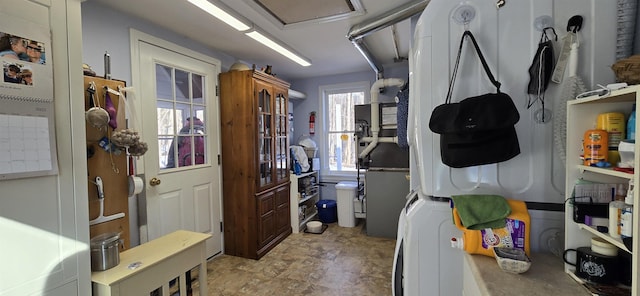 interior space with stacked washer and clothes dryer