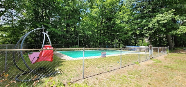 pool with a lawn and fence