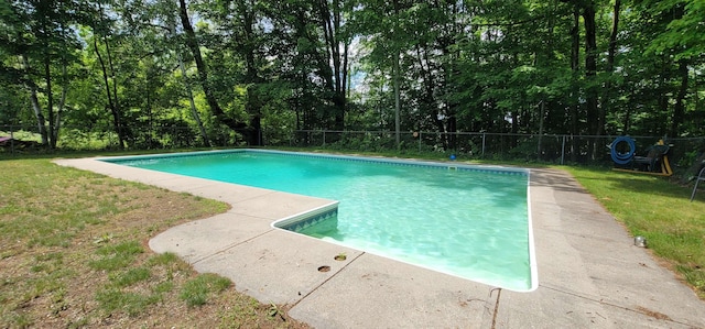 view of swimming pool featuring a yard, a fenced in pool, and a fenced backyard