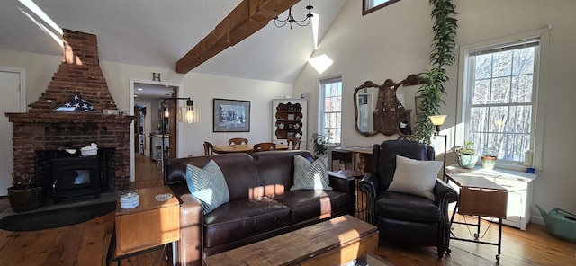 living area with beam ceiling, wood-type flooring, and high vaulted ceiling