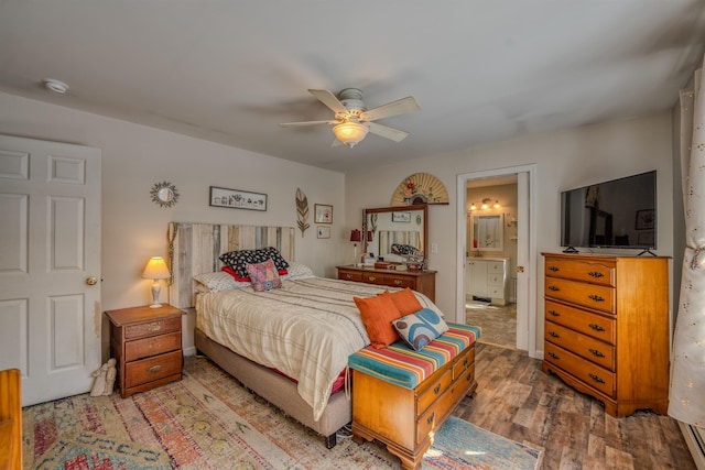 bedroom featuring ensuite bathroom, ceiling fan, and wood finished floors