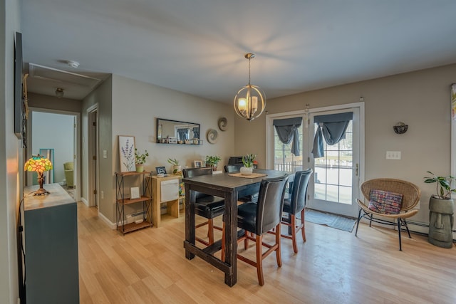 dining area featuring light wood-style flooring and baseboards