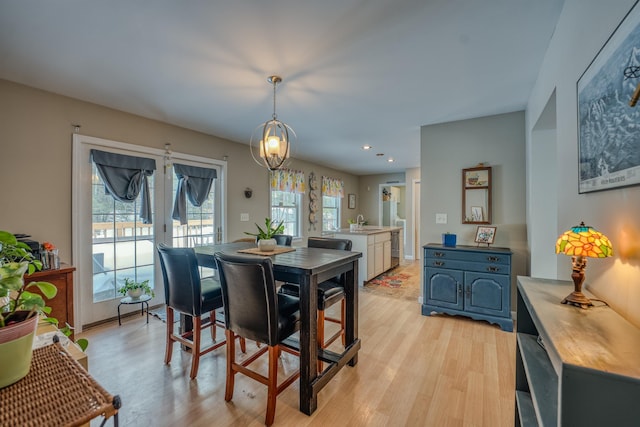 dining space featuring recessed lighting, baseboards, and light wood finished floors