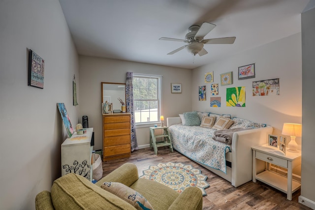 bedroom featuring a ceiling fan, wood finished floors, and baseboards