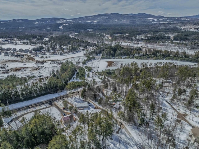 snowy aerial view with a mountain view