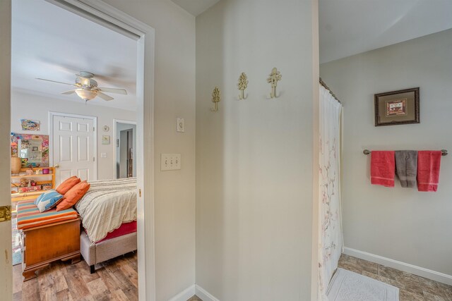 full bath with ceiling fan, curtained shower, connected bathroom, and baseboards