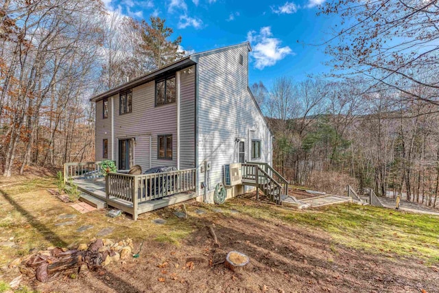 exterior space with a yard and a wooden deck