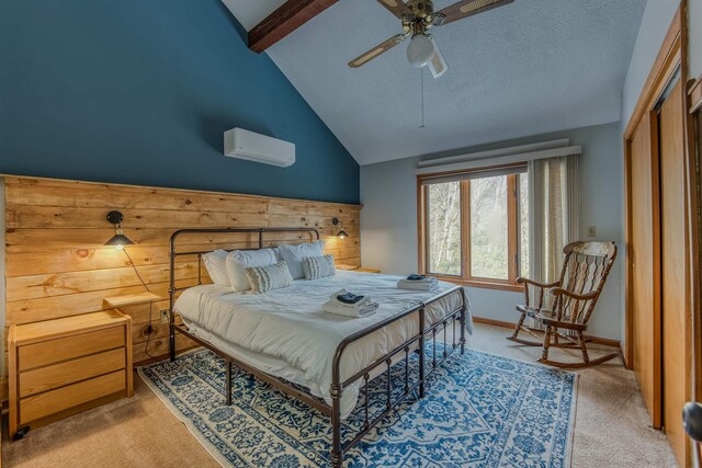 bedroom with lofted ceiling with beams, light colored carpet, baseboards, and a wall mounted air conditioner