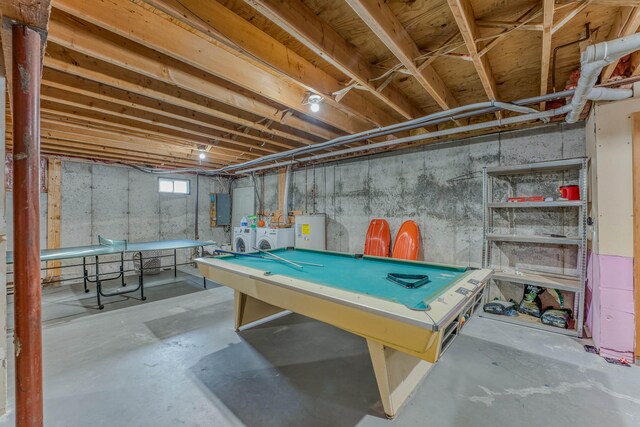 recreation room featuring electric panel, separate washer and dryer, water heater, pool table, and unfinished concrete flooring