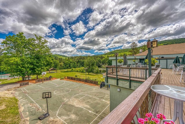 exterior space with a lawn and community basketball court