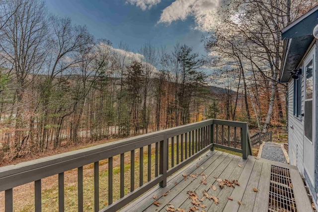 wooden deck with a view of trees