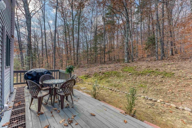 wooden deck with a forest view