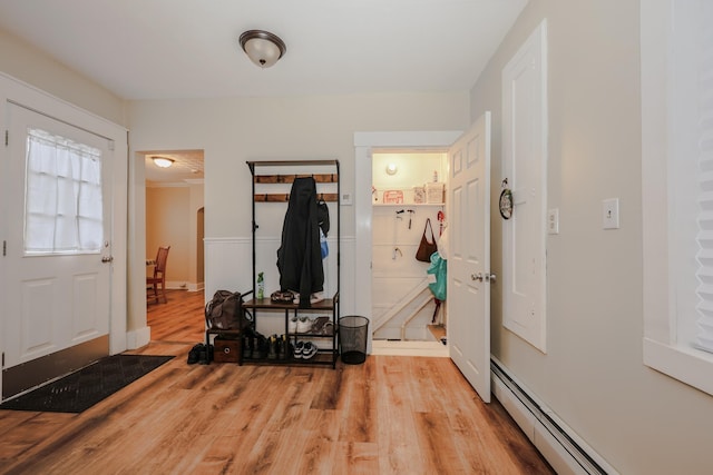 entrance foyer featuring light wood-type flooring and baseboard heating