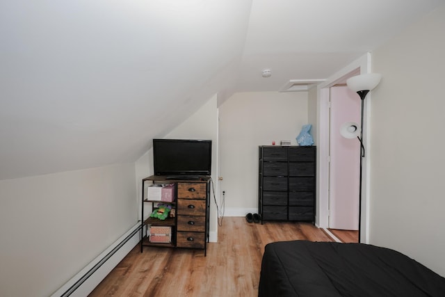 bedroom with lofted ceiling, attic access, light wood-style floors, and baseboard heating