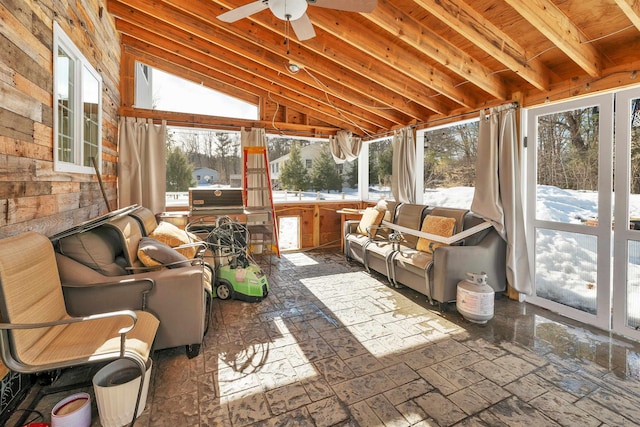 sunroom / solarium featuring a ceiling fan and vaulted ceiling