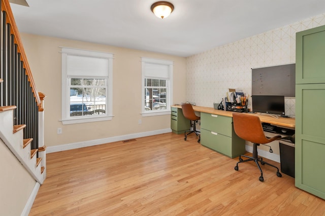 office area featuring visible vents, light wood-style floors, and baseboards