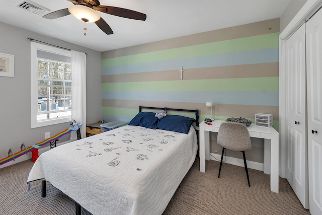 carpeted bedroom featuring a ceiling fan, baseboards, visible vents, and a closet