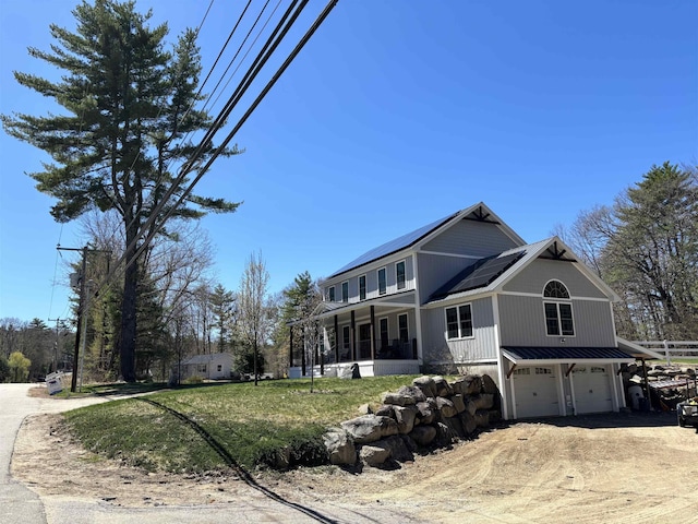 258 Odell Hill Rd, Conway, NH 03813 - view of front facade with dirt driveway, solar panels, and a garage