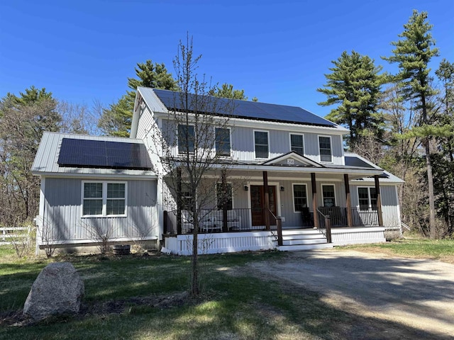 258 Odell Hill Rd, Conway, NH 03813 - view of front of property with board and batten siding, covered porch, a front yard, and solar panels