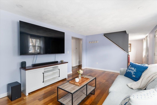 living room featuring baseboards and wood finished floors