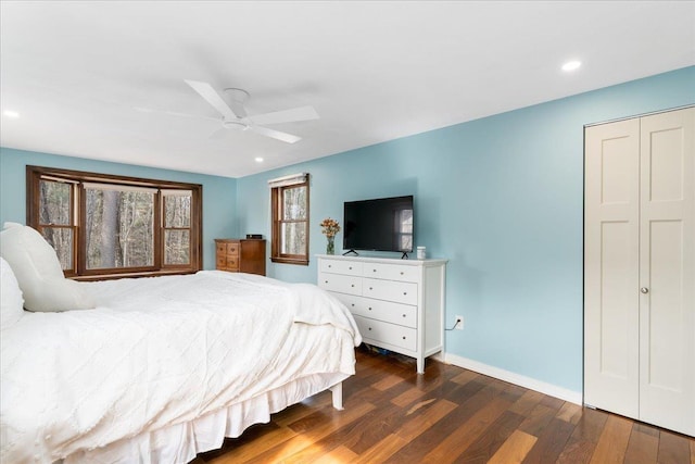 bedroom with a ceiling fan, wood finished floors, recessed lighting, a closet, and baseboards