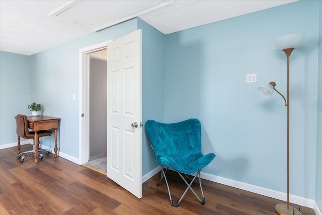 living area with attic access, dark wood-style floors, and baseboards