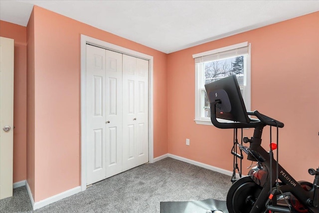 workout room with baseboards and carpet floors