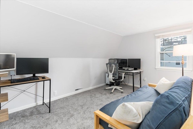 office space with visible vents, baseboards, lofted ceiling, and carpet floors