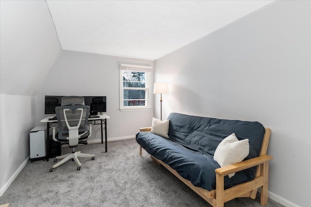 carpeted office space with baseboards and lofted ceiling