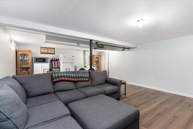 living room with baseboards and dark wood-type flooring